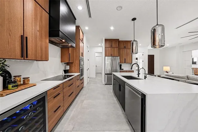 a kitchen with stainless steel appliances a sink stove and cabinets