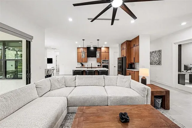 a living room with furniture and a chandelier