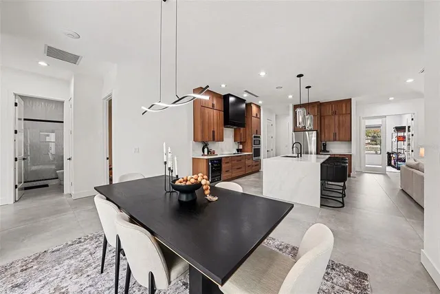 a living room with furniture and a dining table with kitchen view