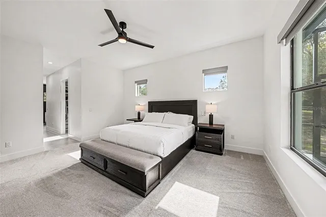 a spacious bedroom with a bed and a window