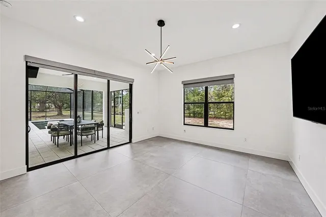 a view of an empty room with window and cabinet