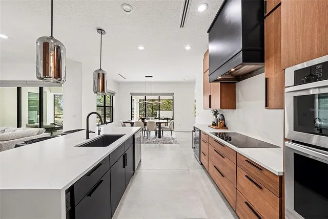 a kitchen with stainless steel appliances a sink stove and refrigerator