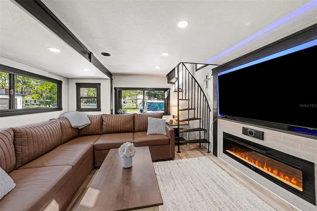 a kitchen with stainless steel appliances granite countertop a stove a kitchen island a refrigerator and cabinets