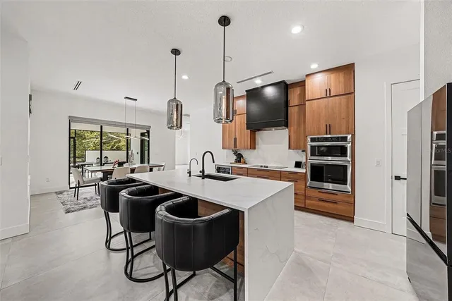 a kitchen with kitchen island a large counter top space appliances and cabinets