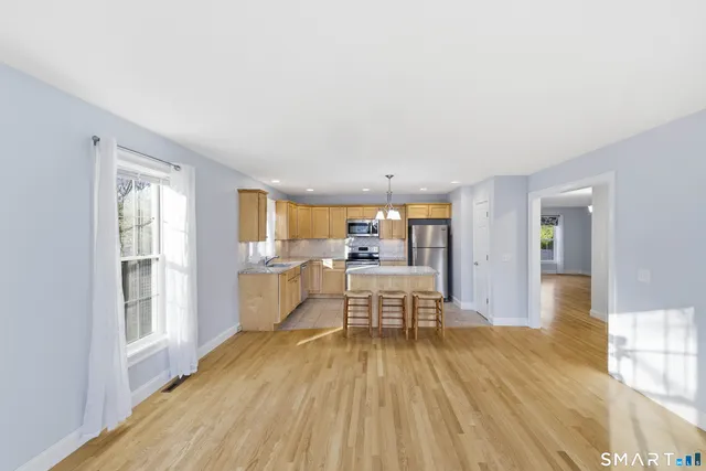 a view of a living room filled with furniture and wooden floor
