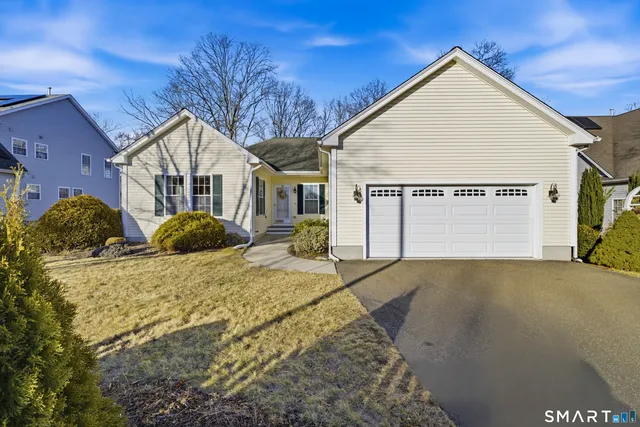a view of a white house with a yard