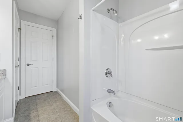 a bathroom with a bathtub and shower
