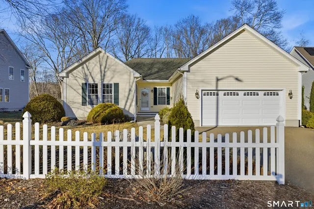 a view of a house with wooden fence