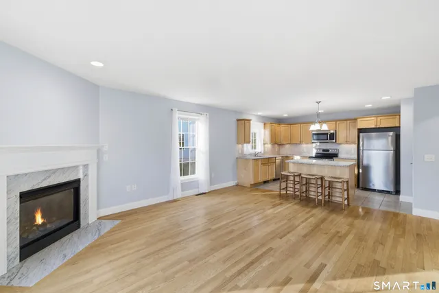 a view of a kitchen with furniture and a fireplace
