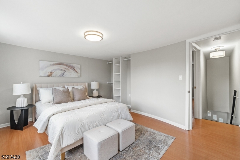 330 John Street Elizabeth, NJ 07202 - Photo 11 of 17 a bedroom with a bed and wooden floor