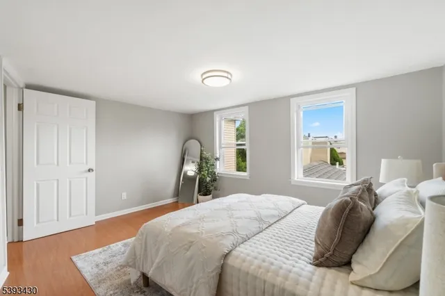 a bedroom with a bed and a lamp with window