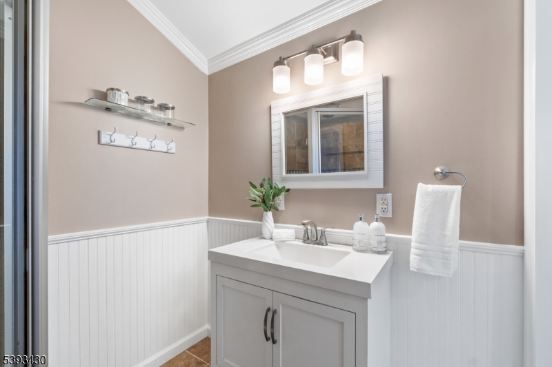 330 John Street Elizabeth, NJ 07202 - Photo 9 of 17 a bathroom with a sink vanity and a mirror