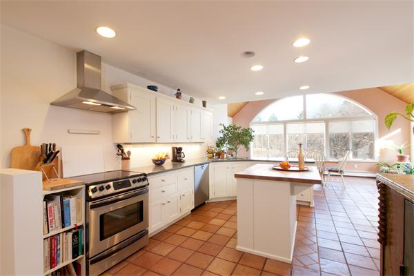 88 Crowell Farm Road Concord, MA 01742 - Photo 3 of 21 a kitchen with a sink a stove and cabinets