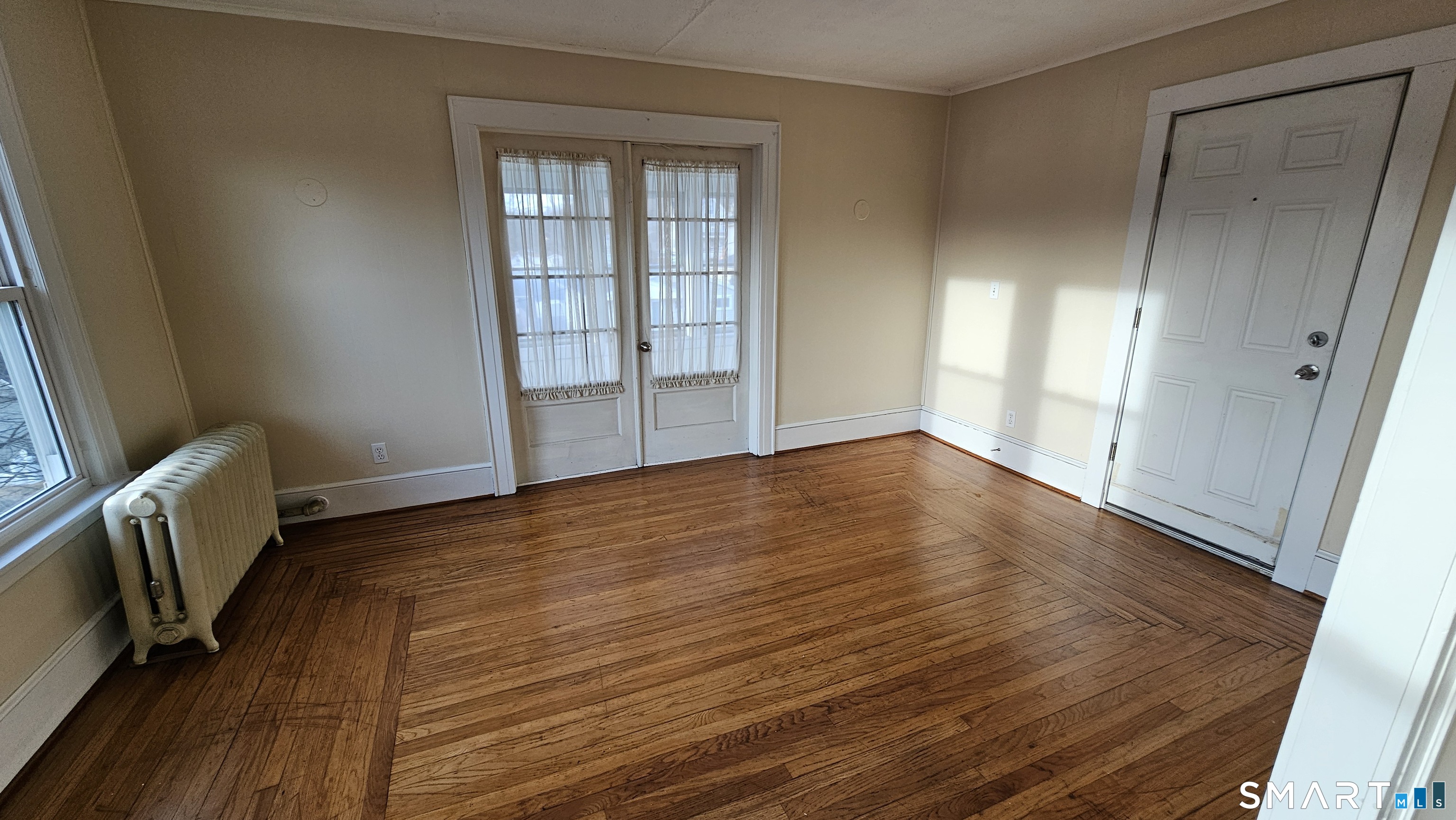 15 Bragaw Street, Unit 3 New London, CT 06320 - Photo 4 of 11 an empty room with wooden floor and windows