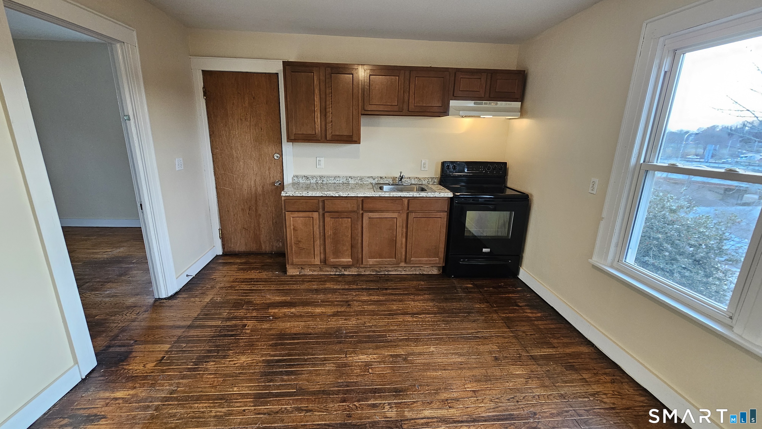 15 Bragaw Street, Unit 3 New London, CT 06320 - Photo 6 of 11 a kitchen with granite countertop a refrigerator and a stove top oven