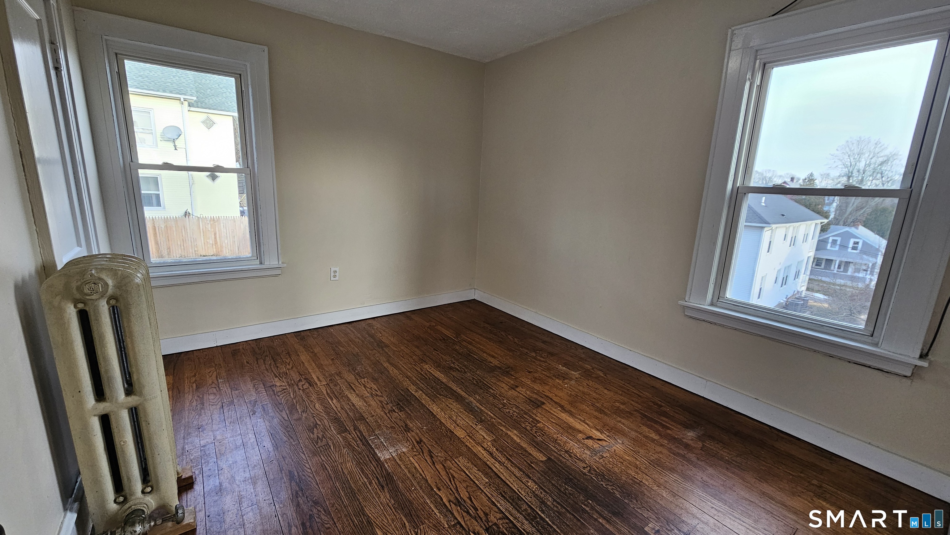 15 Bragaw Street, Unit 3 New London, CT 06320 - Photo 8 of 11 a view of an empty room with wooden floor and a window
