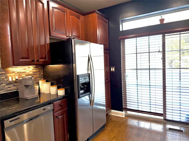 a kitchen with a sink a refrigerator and cabinets