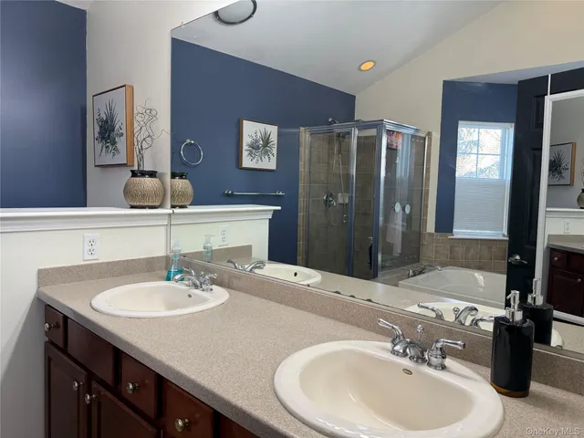 a bedroom with a bed a dresser and mirror