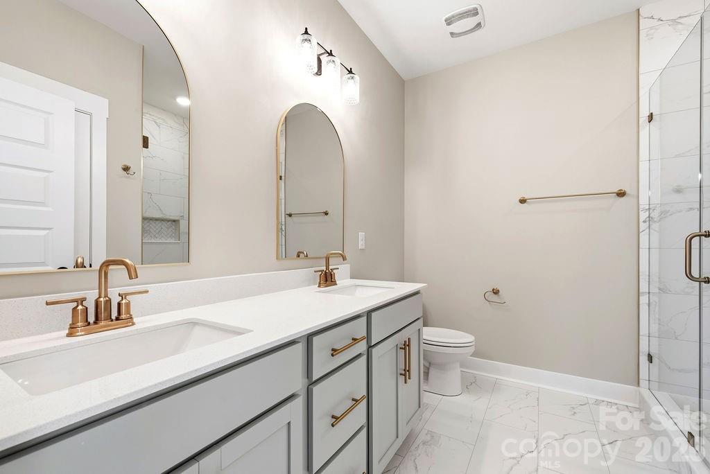 1020 Baylor Grove Road, Unit 20 Monroe, NC 28112 - Photo 36 of 45 a bathroom with a sink a toilet and a mirror