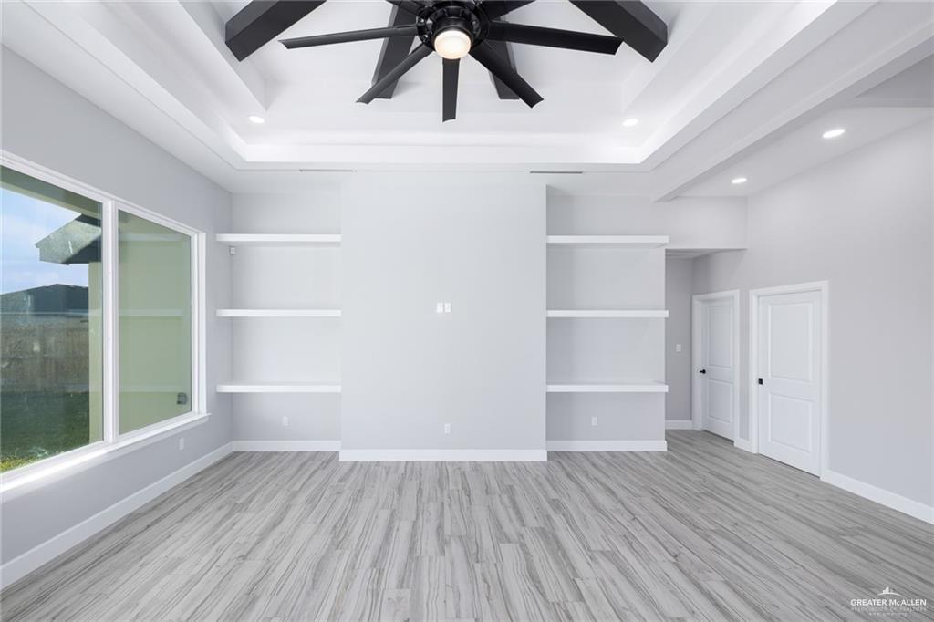 3304 East Rabbit Run Avenue Alton, TX 78573 - Photo 2 of 19 a view of an empty room with a window and wooden floor