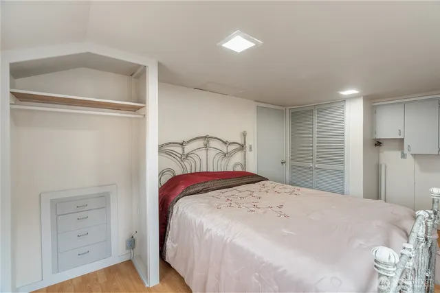 a bedroom with a bed and a closet