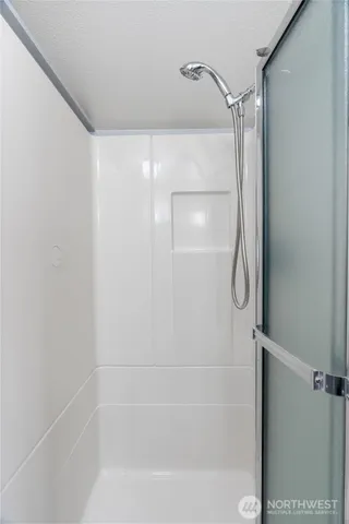 a bathroom with a glass shower door
