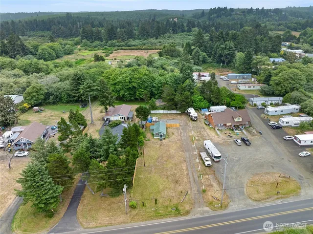 an aerial view of residential houses with outdoor space and swimming pool
