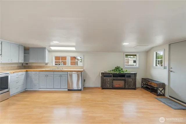 a kitchen with stainless steel appliances granite countertop a stove and a refrigerator