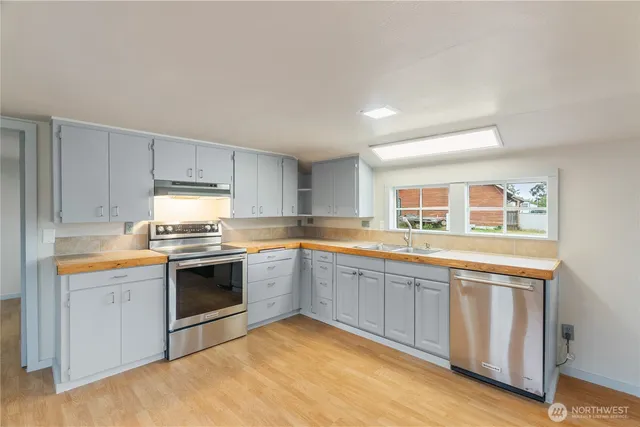 a kitchen with granite countertop stainless steel appliances and sink
