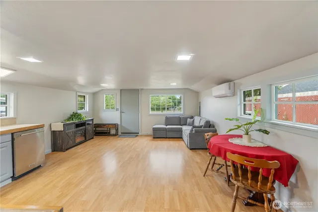 a living room with furniture and wooden floor