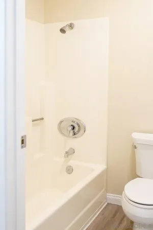 a bathroom with a bathtub and a toilet