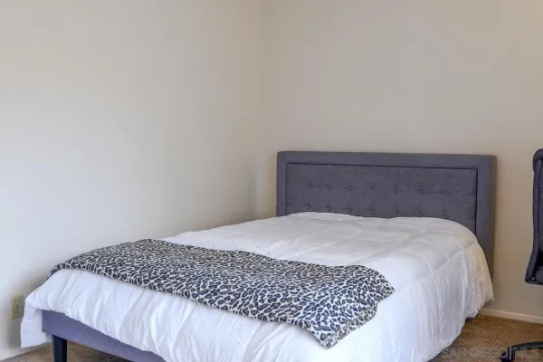 a bedroom with a bed and a chair