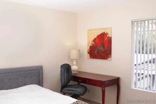 a room with a wall paintings and a lamp