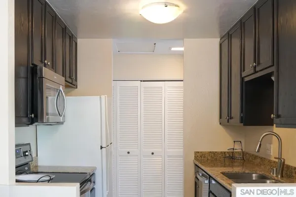 a kitchen with a sink and a refrigerator