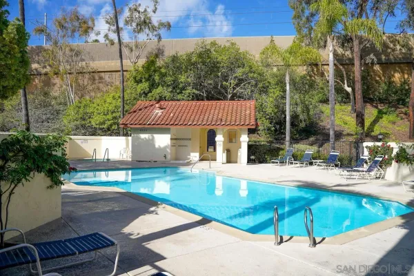 swimming pool view with a seating space
