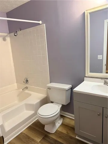 a bathroom with a toilet a sink and bathtub