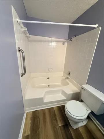 a view of a room with wooden floor