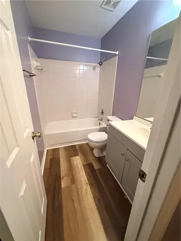 a bathroom with a sink a toilet a tub and shower