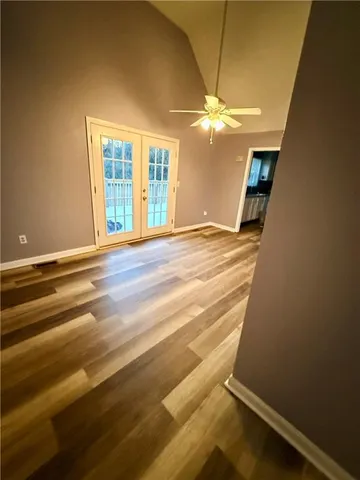 a view of a room with wooden floor and fan
