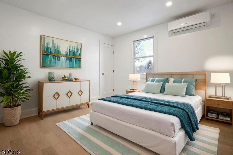 554 Hort Street Westfield, NJ 07090 - Photo 2 of 19 a spacious bedroom with a bed a window and potted plant