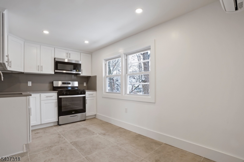 554 Hort Street Westfield, NJ 07090 - Photo 5 of 19 a kitchen with stainless steel appliances granite countertop a stove a sink and a microwave
