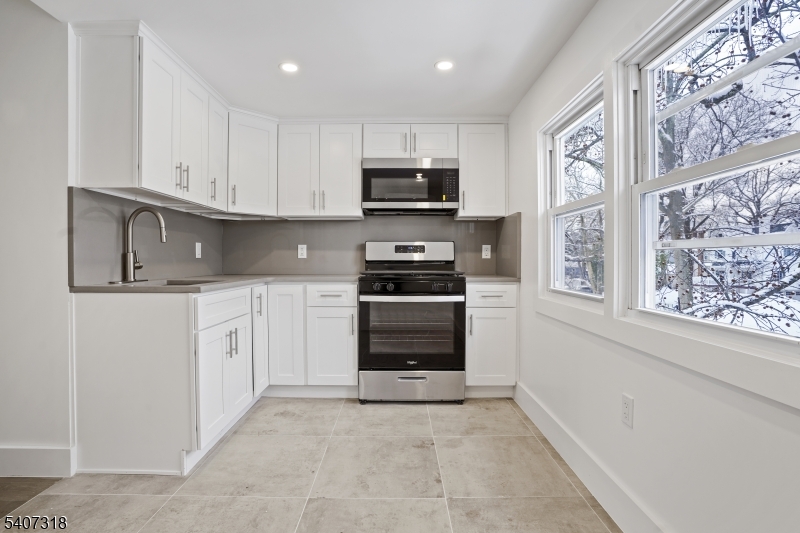554 Hort Street Westfield, NJ 07090 - Photo 7 of 19 a kitchen with white cabinets and appliances