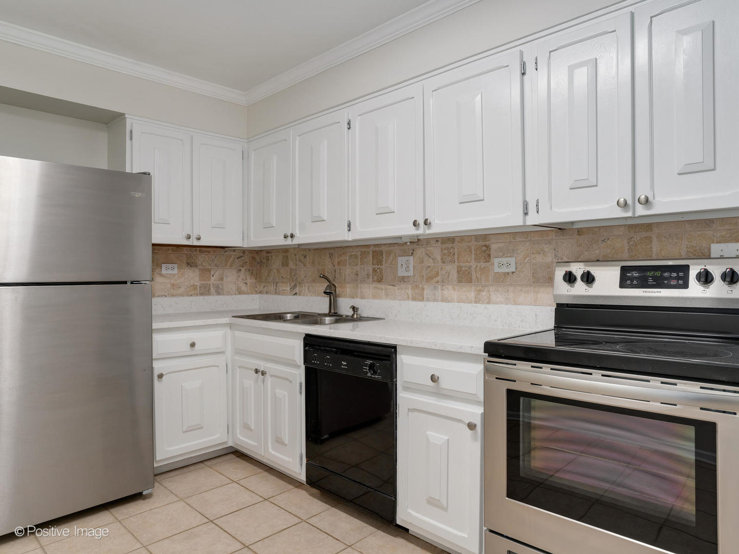 2407 South Goebbert Road, Unit 201 Arlington Heights, IL 60005 - Photo 7 of 20 a kitchen with white cabinets and white appliances