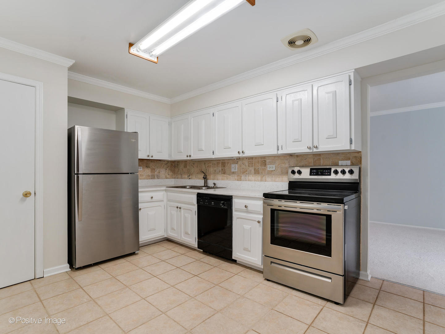 2407 South Goebbert Road, Unit 201 Arlington Heights, IL 60005 - Photo 9 of 20 a kitchen with a stove top oven and refrigerator
