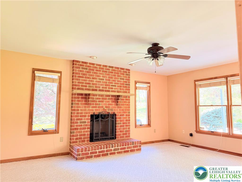 4165 Alder Road Bethlehem, PA 18020 - Photo 15 of 42 a living room with a fireplace furniture and a window
