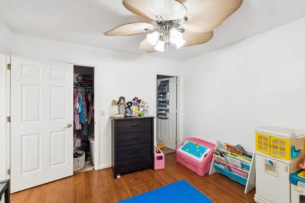 a bedroom with bed and wooden floor