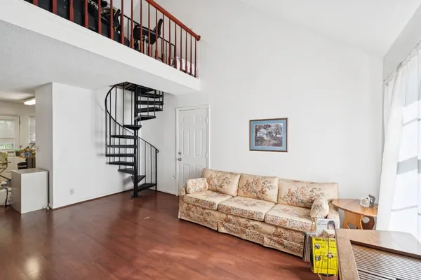a living room with furniture and wooden floor