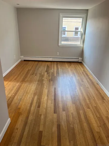a view of an empty room and wooden floor