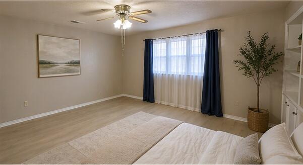 5722 75th Street Lubbock, TX 79424 - Photo 14 of 29 a bedroom with a bed and a chandelier