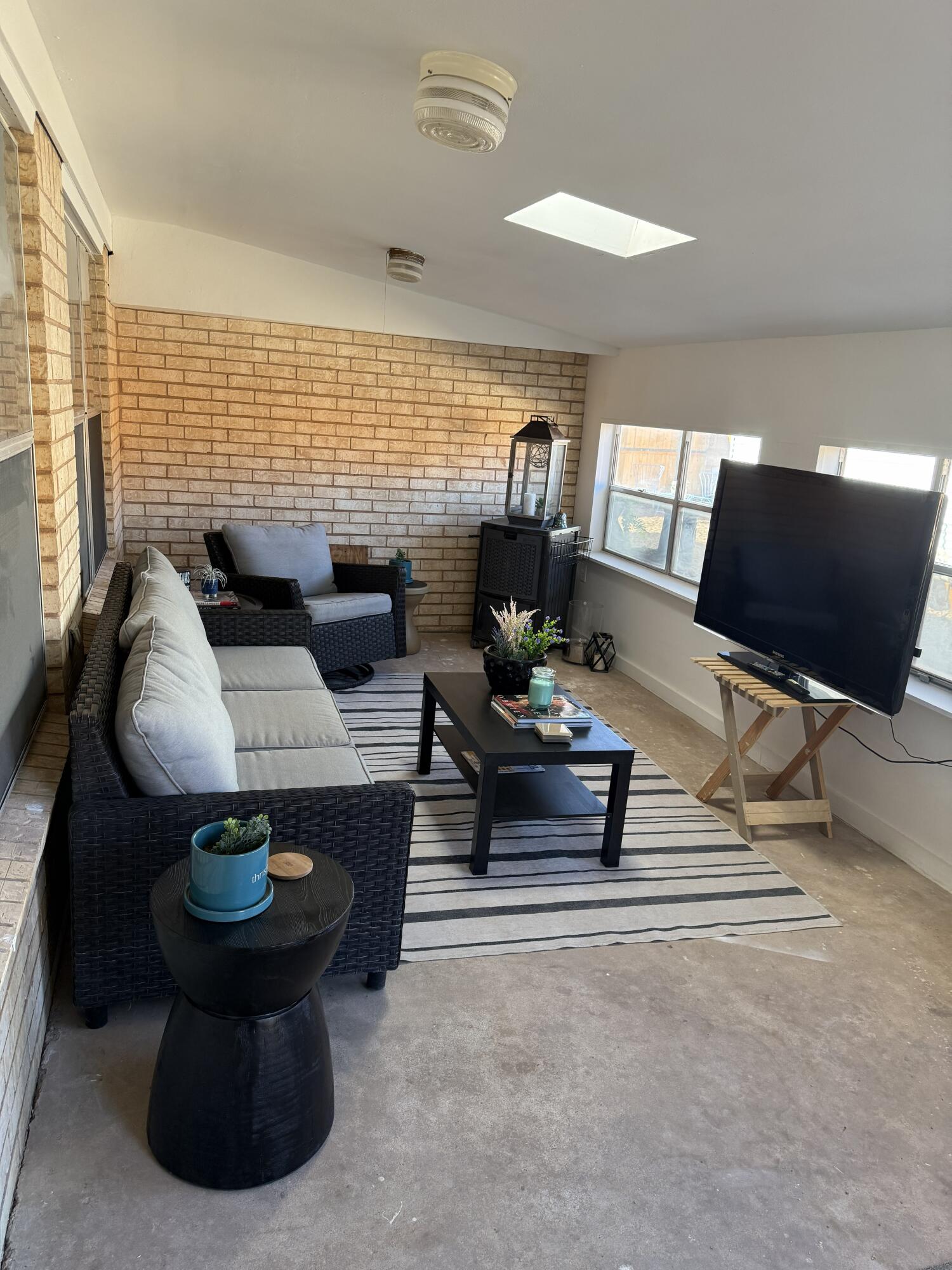 5722 75th Street Lubbock, TX 79424 - Photo 18 of 29 a living room with furniture a table and a large window